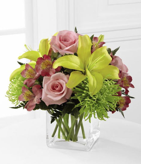 Bright roses and sunny Asiatic lilies to congratulate your special recipient on a job well done! Pink roses, green Fuji chrysanthemums, pink Peruvian lilies, yellow Asiatic lilies and lush greens.