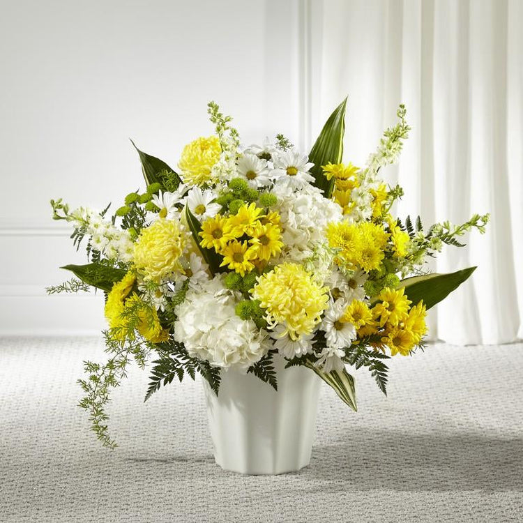 This stunning arrangement features an uplifting mix of hydrangea, larkspur, daisy pompons and mums. STANDARD SIZE